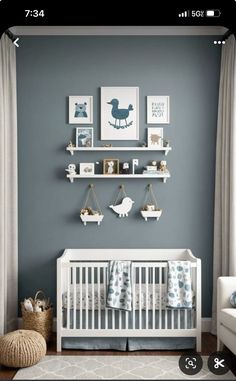 a baby's room with gray walls and white furniture