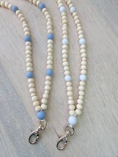 two white and blue beaded necklaces on a table