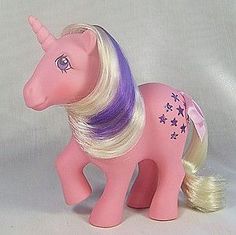 a pink toy pony with blonde hair and purple manes on it's tail