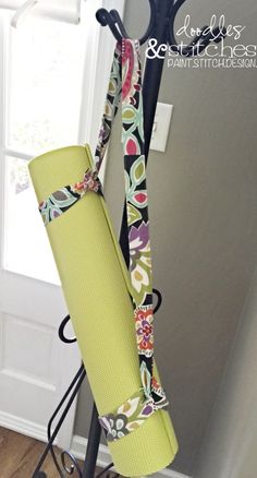 a pair of yoga mats are hanging on a rack in front of a door and window