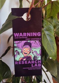 a sign hanging from a plant that says, warning very unstatable research lab