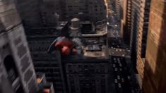 a spider - man standing on top of a tall building