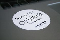 a sticker that says have joy on the side of a laptop computer keyboard,