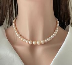 Gorgeous Genuine Pearl Necklace with Matching Earrings in 925 Sterling Silver . Beautiful accessory for Wedding/bridesmaid/Party. Lustrous ivory Peach Pearls  Ps : Pearls do have natural free form Flaws  12 -10 - 8 mm Pearls in Necklace 18 inches length Big size lobster clasp Peach Necklace Gift, Peach Round Necklace Gift, Peach Round Necklace For Gift, Round Peach Necklace For Gift, Gift Round Peach Necklace, Classic Cream Jewelry As A Gift, Elegant Peach Round Bead Jewelry, Elegant Adjustable Apricot Jewelry, Elegant Peach Round Beads Jewelry