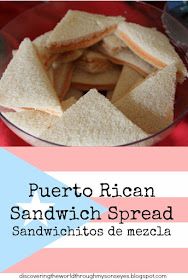 a bowl filled with sandwiches sitting on top of a red tablecloth covered table cloth