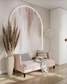 a living room with a pink couch and white vases on the floor next to it