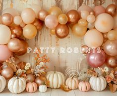 there are many balloons and pumpkins on the table