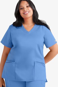 Fit for plus-size women, our short-sleeve style has strategically placed front and back darts for an incredibly flattering, streamlined look. Each piece in our Butter-soft Stretch scrub collection was designed for 12+ hour shifts, and made from easy-care, 2-way stretch comfort fabric. • Relaxed fit • V-neck • Total of 4 pockets • 2 front double pockets • Front and back darts • Short sleeve • Side slits • Approximate length for size 1x is 29 The key to comfort? Cotton and 2-way stretch. They’ve m Plus Size Scrubs, Medical Scrubs For Women, Plus Size Scrubs Woman, Scrub Suit Design, Nursing Scrubs Outfits, Scrub Skirts, Plus Size Scrubs Woman Medical, Teal Scrubs Nursing, Nurse Outfit Scrubs