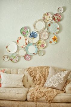 a living room filled with furniture and plates on the wall