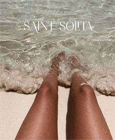 a woman's legs are shown in the sand at the beach, with the words saint soutat above them