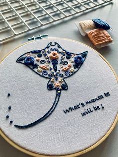 A manta ray outline filled with embroidered doodles like swirls, leaves, flowers, and dots. In blues and creams and peach colours. On a white cotton fabric in a 6-inch wooden embroidery hoop Embroidery Shark Pattern, Ocean Hand Embroidery, White Rose Embroidery, Manta Ray Embroidery, Embroidery Sea Life, Stingray Embroidery, Manatee Embroidery, What To Do With Embroidery Projects, Crochet Manta Ray