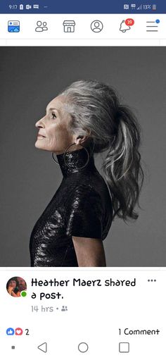 an older woman with grey hair and black dress on facebook, looking up at the sky