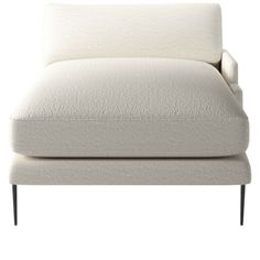 a white couch with black legs and pillows