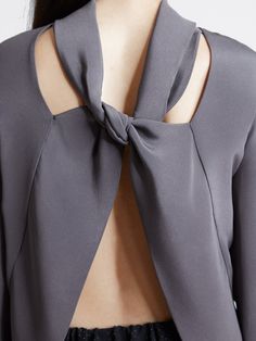 This elegant 2-ply silk crepe top has a looped tie at the back neck, framing an open back. Tuck this charcoal gray beauty into a high waisted skirt or pant for a more subtle look, or wear it loose and open! Made in New York City. 100% silk *Made to order. Please allow 2 weeks for production. MEASUREMENTS Small: Shoulder : 14" / Bust: 34-35" / Sleeve Bicep: 12" Medium: Shoulder: 14.5" / Bust: 35-37" / Sleeve Bicep: 13" Large: Shoulder: 15" / Bust: 38-41" / Sleeve Bicep: 14" Need help? Contact us Back Detail Top, Back Tuck, Flannel Suit, Top Street Style, Future Clothes, Crepe Top, Knot Dress, Sewing Design, Cocktail Evening Dresses