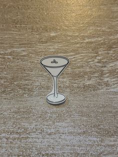 a small glass sitting on top of a wooden table