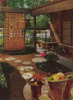 an outdoor patio with stone walkways and potted plants