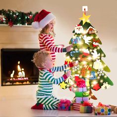 two young children decorating a christmas tree