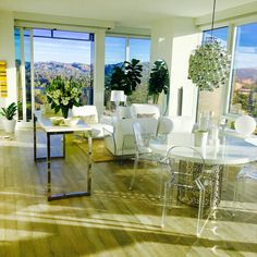 a living room filled with lots of furniture and large windows overlooking the cityscape