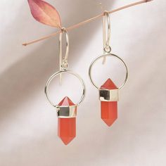 With these Carnelian Crystal Point Earrings, boost your bravery and carry courage wherever you go. Flickering with fire and vitality, these crystal point earrings celebrate the joie de vivre that is the Carnelian stone. 
“With these earrings, I am loaded with spiritual warmth, universal protection, and self-power.”
Description
These Carnelian crystal point earrings are the ultimate warrior stone. Warm in shades of red and orange, Carnelian has a reputation for being a gemstone that speaks to those lower chakras, helps ward off negative emotions like envy and rage, and even acts as an ancient stone of fertility. Carnelian is a warrior gem worn on the battlefield. Not only is this stone blessed and loaded with protection, but it helps you feel fit and strong (mentally and physically) and cha Crystal Point Jewelry, The Ultimate Warrior, Lower Chakras, Fit And Strong, Intention Bracelets, Spiritual Necklace, Hematite Crystal, Crystal Anklet, Orange Carnelian