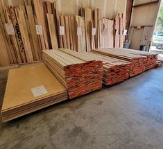 several stacks of wooden boards in a warehouse