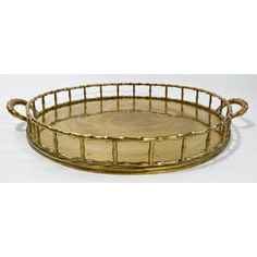 a round bamboo tray with handles on the bottom and sides is shown in gold color