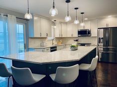 a kitchen with an island and chairs in it