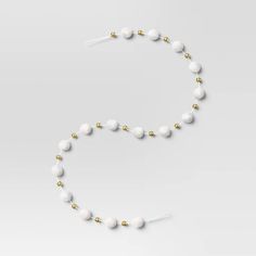 a white beaded necklace with gold accents on a white background, it looks like something from the movie star wars