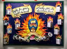 a bulletin board with some pictures on it and fire coming out of the back ground