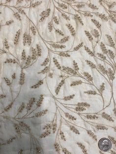 Distinguished by its luxurious design, this high-quality Khaki Sequins & Beads on Silk Chiffon JEC-176-3 Fabric is perfect for women's high-end evening dresses, costumes, jackets, and skirts. Our unique and distinctive fabric is available in a wide selection of colors. The fabric is sold by the Yard, and measures 44 inches in width. Elegant Beaded Sequin Fabric, Elegant Festive Embroidered Georgette Fabric, Elegant Embellished Embroidered Fabric, Festive Elegant Organza Embroidered Fabric, Elegant Embellished Embroidered Fabric For Festive Season, Glamorous Embellished Embroidered Fabric For Festive Occasions, Elegant Festive Silk Embroidered Fabric, Elegant Silk Embroidered Fabric For Festive Season, Elegant Festive Embroidered Organza Fabric