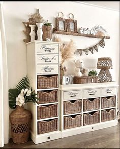 a white cabinet with wicker baskets on the top and drawers below, along with other items