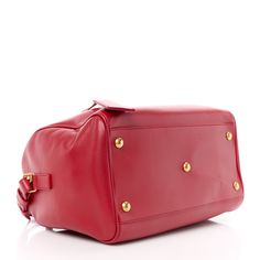 This is an authentic SSAINT LAURENT Calfskin Classic Duffle 6 in Red. This luxurious duffle is crafted of smooth calfskin leather. The bag features rolled leather top handles with brass links and an optional leather shoulder strap with brass hardware. The top zipper opens to a matching suede interior with pockets. Brass Hardware, Leather Top, Top Handle, Calf Skin, Saint Laurent, Shoulder Strap, Handles, Brass, Zipper