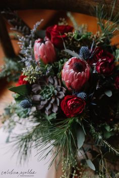 a bouquet of flowers sitting on top of a wooden chair