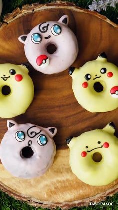 four donuts with faces painted on them in the shape of cats and kittens