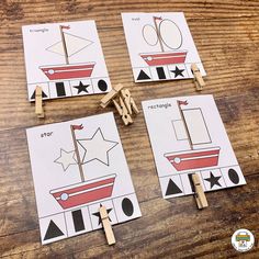 four wooden clothes pegs with pictures of boats and stars on them sitting on a table