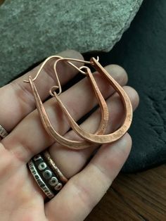 This style hoop earrings are a classic design and perfect for everyday wear. Each pair is forged by hand from recycled copper and have a celtic / modern viking style. Choose from rustic (last photo) or raw copper finish.  Hoops are made to order just for you! Copper is the traditional gift for the 7th anniversary. MEASUREMENTS & SPECIFICS:Shown in rustic copper and raw brass.  SIZE: approximately 5 x 4 cm (custom sizes available convo before ordering)EARWIRE: choose from copper or Sterling s Hammered Copper Hoop Earrings As Gift, Copper Hammered Hoop Earrings As Gift, Artisan Copper Earrings For Everyday Wear, Artisan Copper Earrings For Everyday, Minimalist Hammered Copper Jewelry, Everyday Hand Forged Bronze Earrings, Hammered Artisan Hoop Earrings For Everyday, Artisan Hammered Hoop Earrings For Everyday, Everyday Hammered Copper Earrings