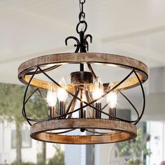 Bring a touch of rustic charm to your home with the 5-light rustic wood cage chandelier. Crafted from beautiful birch wood and metal, this chandelier features five candle-shaped lamp bases suspended from wood and an adjustable chandelier chain extending up to 70 in.. Ideal for both dining and living areas, this chandelier is designed to accommodate sloped ceilings of up to 15 °. While the required bulbs of up to 40 Watts each are not included, the chandelier promises an easy setup. It comes with Wood And Metal Chandelier, Cage Chandelier, Wooden Chandelier, Farmhouse Pendant Lighting, Farmhouse Chandelier, Inspire Me Home Decor, Wood Chandelier, Geometric Chandelier, Metal Hanging Lights