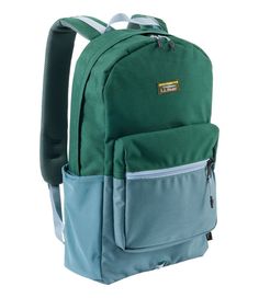 a green and blue backpack on a white background