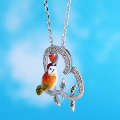 Designed for the free-spirited, the kingfisher is symbolic of freedom, courage, adventure, and balance. Each piece has been delicately hand-painted, displaying the uniqueness of its bright yellow feathers and orange plumage against a silver base. It is a true gift to spot one of these elusive creatures in nature.Carat Weight: 0.341 ctStone Size: 1,3*3,0.8 mmStone Type: Jeulia® StoneNumber of Stones: 44 Stone Shape: Round, HeartStone Color: Diamond White, Garnet RedChain Type: Cable chainWeight: Unique Bird Design Pendant Jewelry, Green Bird Design Jewelry Gift, Green Jewelry With Bird Design As Gift, Green Jewelry With Bird Design For Gift, Whimsical Artistic Jewelry For Gifts, Whimsical Artistic Design Jewelry Gift, Whimsical Artistic Design Jewelry For Gift, Whimsical Bird Design Jewelry For Gifts, Whimsical Bird Design Jewelry For Gift