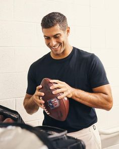 a man holding a football in his hand