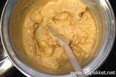 a metal pot filled with batter on top of a stove