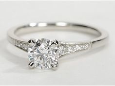 a diamond engagement ring on a white background