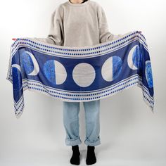 The moon shows all its faces in "Phases". Shades of blotted blue punctuate every corner of the night sky. Stare wistfully at the stars bundled up in this versatile scarf.   Inspiration: Learning About Our World, 1932 - Soft cotton blend - Fan favorite 72" x 18" size - Versatile styling options - Timeless book-inspired design - Perfect for all-season wear Scarf Inspiration, Blue Accessories, Whimsical Fashion, Wedding Board, Hope Chest, Moon Phases, Book Lovers Gifts, Night Sky, Lace Up Boots