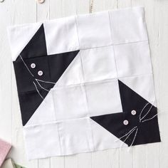 a black and white piece of fabric with buttons on it