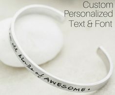 two white bracelets with the words, custom personalized text and font on them