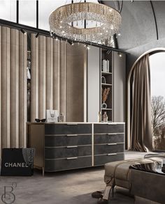 a chandelier hangs from the ceiling above a dresser in a modern living room