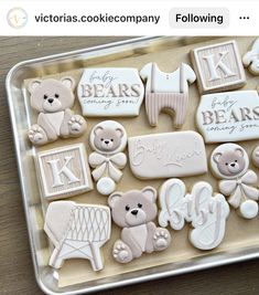 decorated cookies in the shape of bears and sheeps on a tray with baby's names