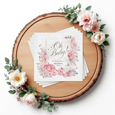 pink flowers and greenery are on top of three napkins