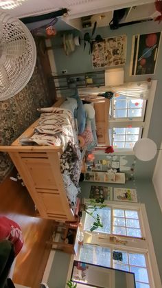 an overhead view of a bedroom with lots of furniture and decor on the walls, windows, and ceiling fan