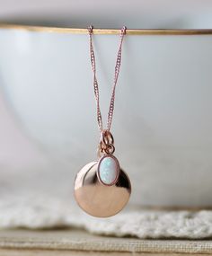 "A sweet new locket made with rose gold and an opal charm. Locket is rose gold plated and hangs from dainty rose gold plated chain. A small opal charm hangs off the side. See details and lengths below. * Locket - 13mm (1/2\") * Singapore chain -Adjusts to 18\" and 20\" only (has small ring to connect clasp at 18\" and 20\" lengths along chain) * Satellite Chain - Adjusts from 16-18\", or 18-20\" * Opal charm - Lab created opal, 6x4mm Please choose desired chain style and length at checkout. List Rose Gold Oval Charms Necklace, Oval Rose Gold Necklaces With Charms, Rose Gold Oval Necklaces With Charms, Rose Gold Locket Necklace With Charms For Gift, Rose Gold Locket Necklace For Mother's Day, Mother's Day Rose Gold Locket Necklace, Rose Gold Charms Necklace Keepsake, Rose Gold Charms Necklace For Keepsake, Rose Gold Charm Necklaces With Locket For Mother's Day