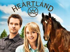 a man and woman standing in front of a horse with the words heartland on it